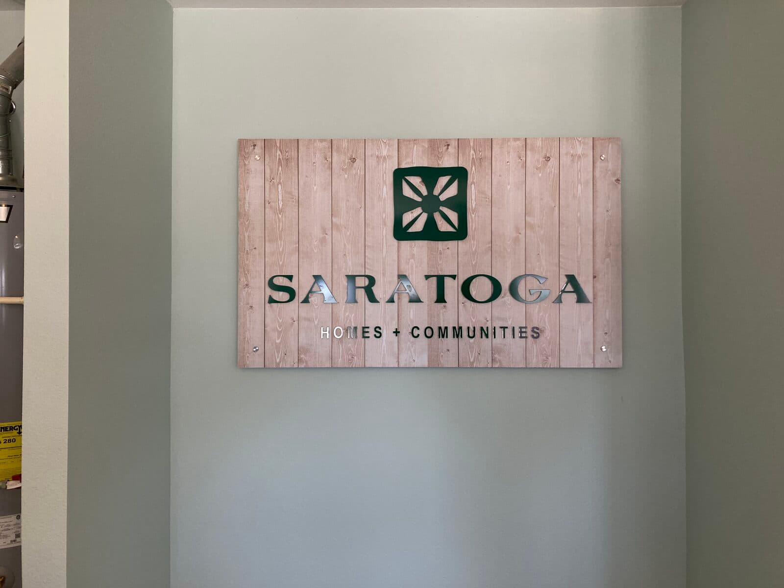 Custom printed wood-look panel with dimensional letters for a home builder